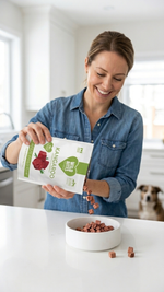 Woman holding a pack of Wild Bites freeze dried kangaroo treats